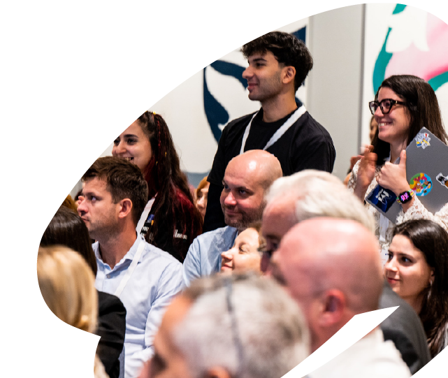 Young participants and attendees engaging during an EU4Youth event, with audience members listening and applauding during a discussion or presentation.