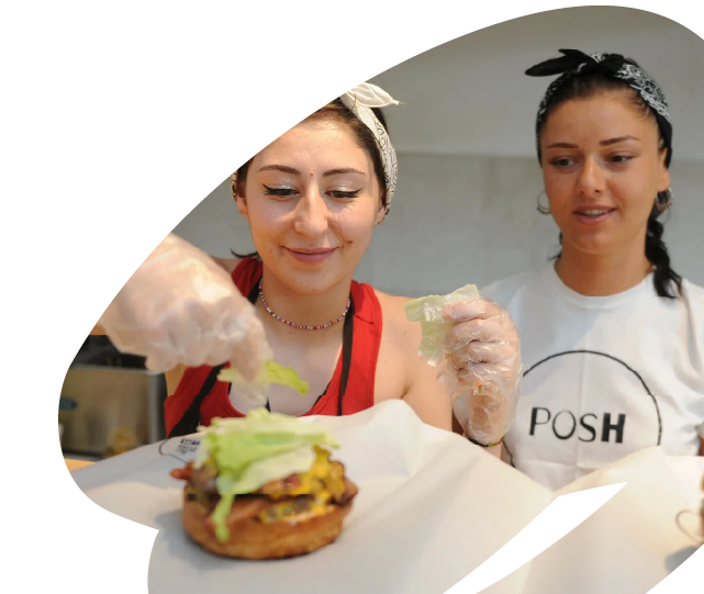 Young women preparing food together during an EU4Youth-supported vocational or entrepreneurship activity, developing practical hospitality or catering skills.