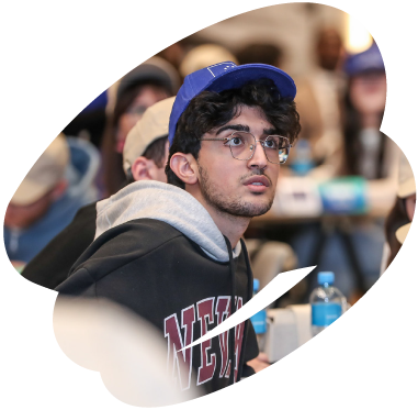 Young participant listening attentively during an EU4Youth training or youth engagement event, seated among other attendees.
