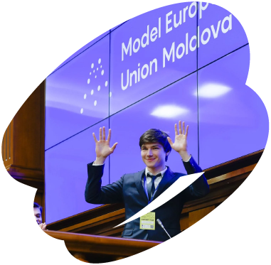 Young participant speaking at a Model European Union Moldova event, standing at a podium and raising his hands during a presentation.
