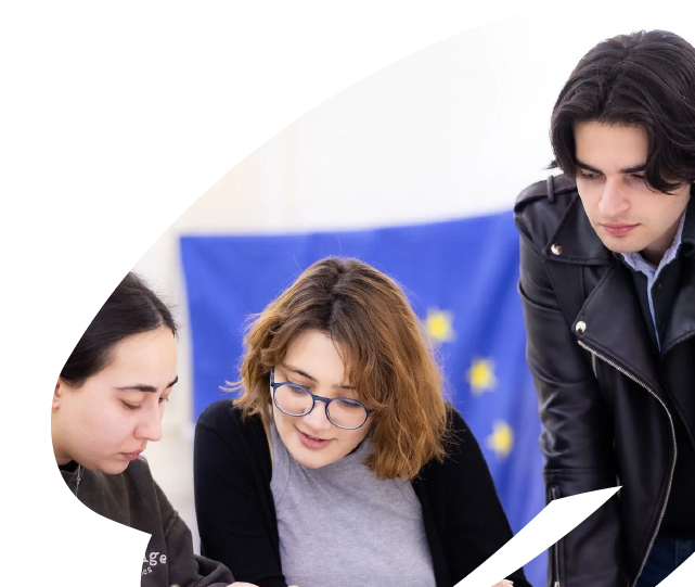 Young participants collaborating during an EU4Youth training or civic engagement activity, reviewing information together in a group setting.