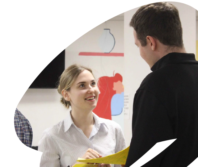 Two participants engaged in conversation during an EU4Youth training or networking activity, discussing ideas in an informal setting.