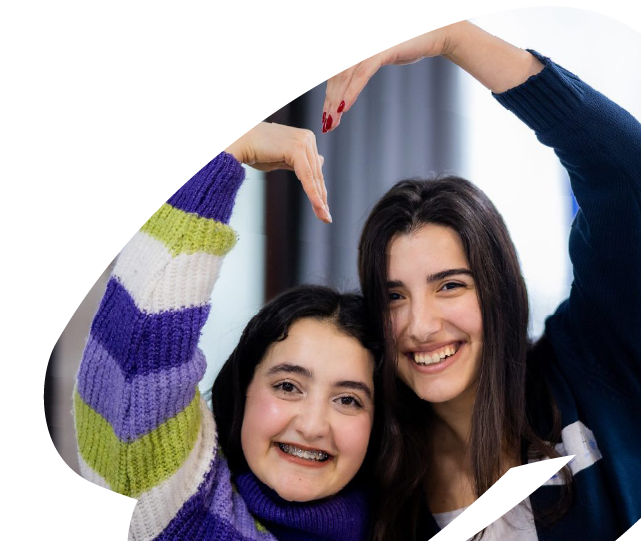 Two young participants smiling together during an EU4Youth activity, expressing friendship, inclusion and positive youth engagement.