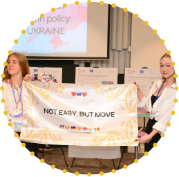 Group of young participants holding national flags and banners during an EU4Youth regional exchange, promoting cross-border cooperation and democratic youth participation.