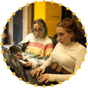 Young participants collaborating on laptops during the Tech4Skills Ideathon in Tbilisi, developing ideas and digital skills through an EU4Youth-supported activity.